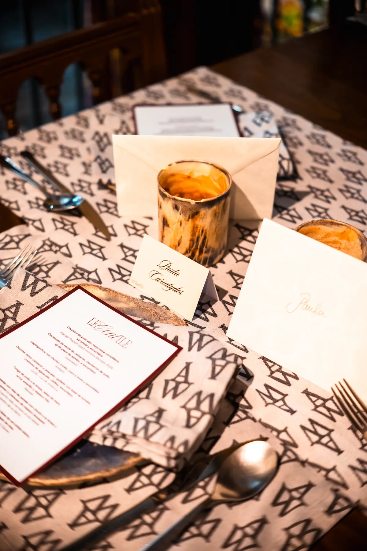 A place setting with the Le Centile menu and a handwritten name card