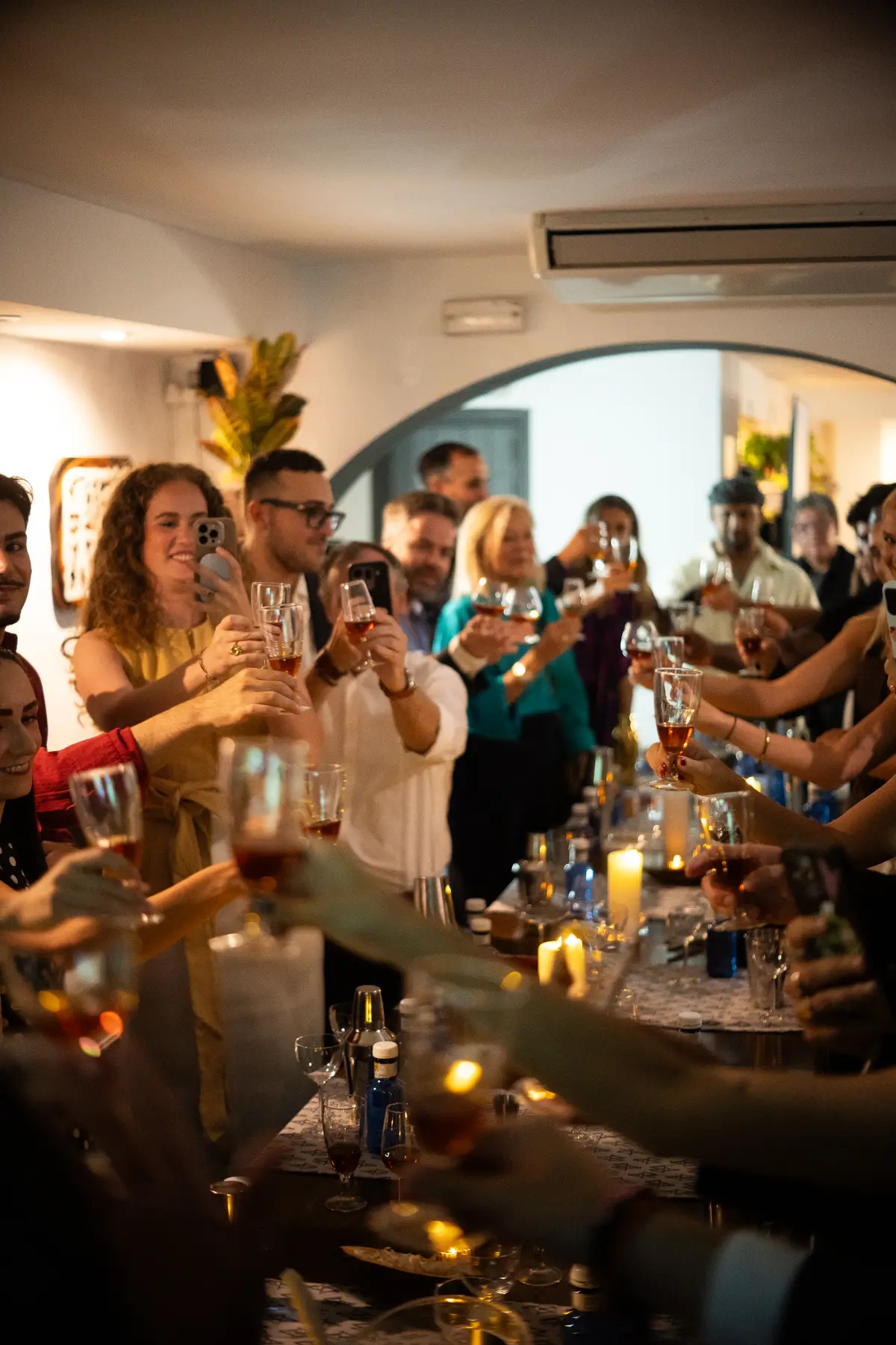 Guests raising their glasses around the table