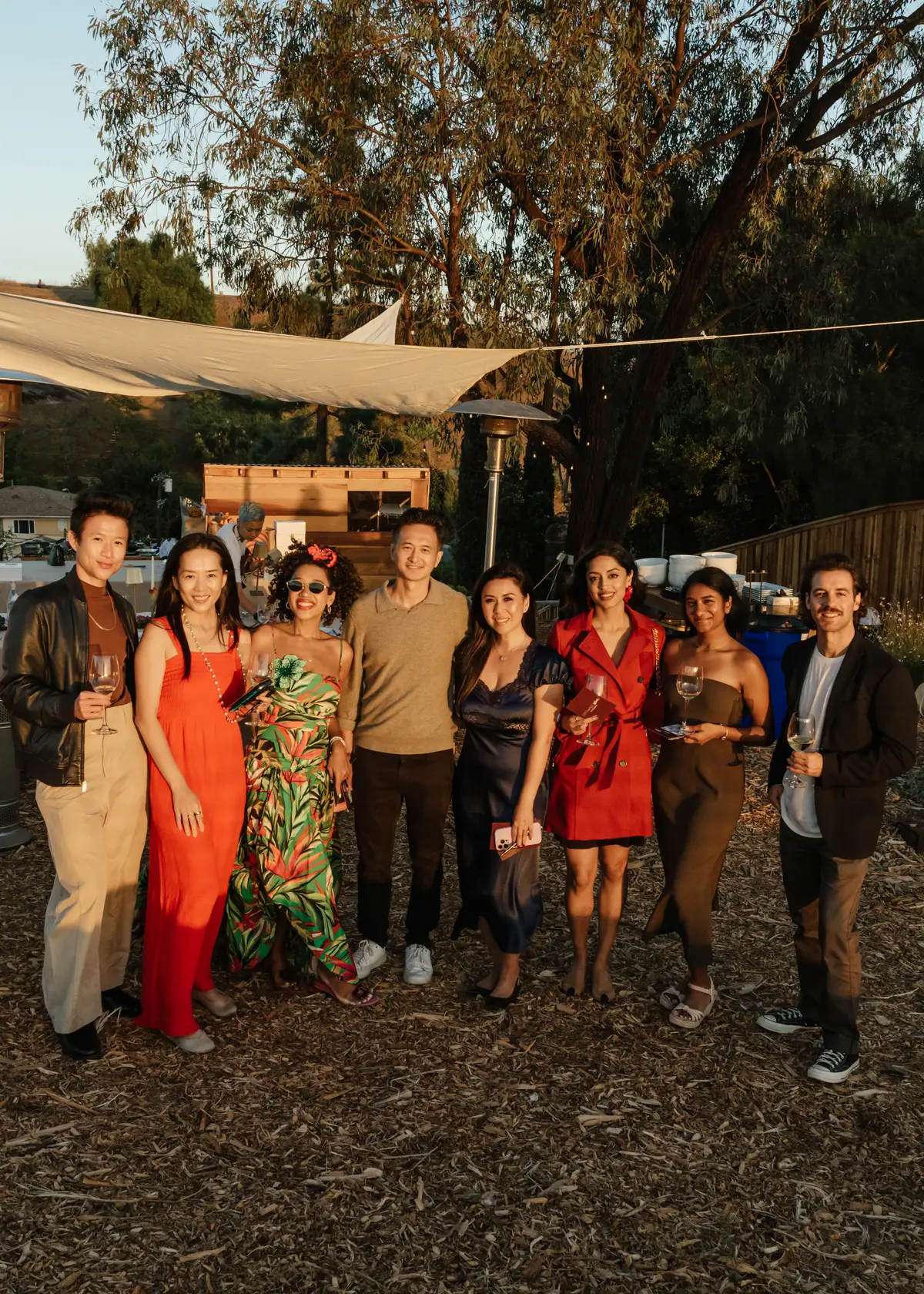A group of guests standing among the trees