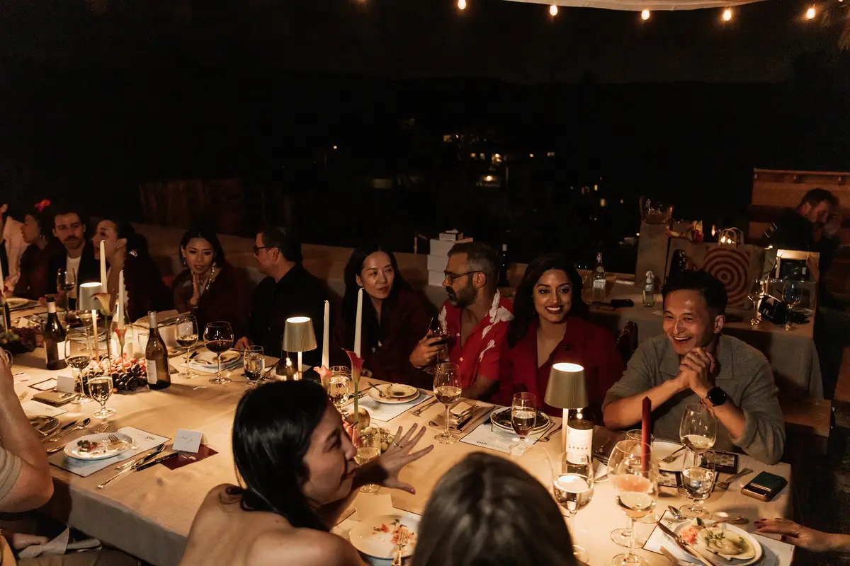 Guests around the table after dark