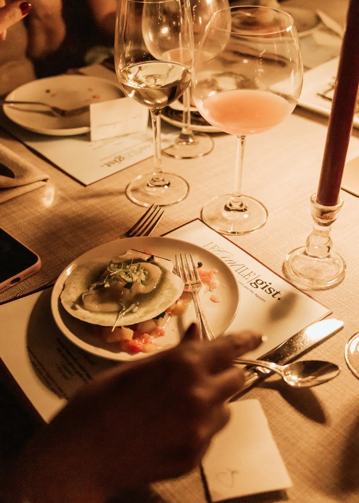 Glasses of rosé and a plate on the dinner table