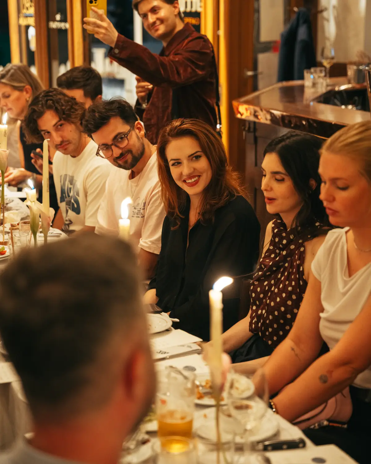 Guests smiling for a selfie at the table