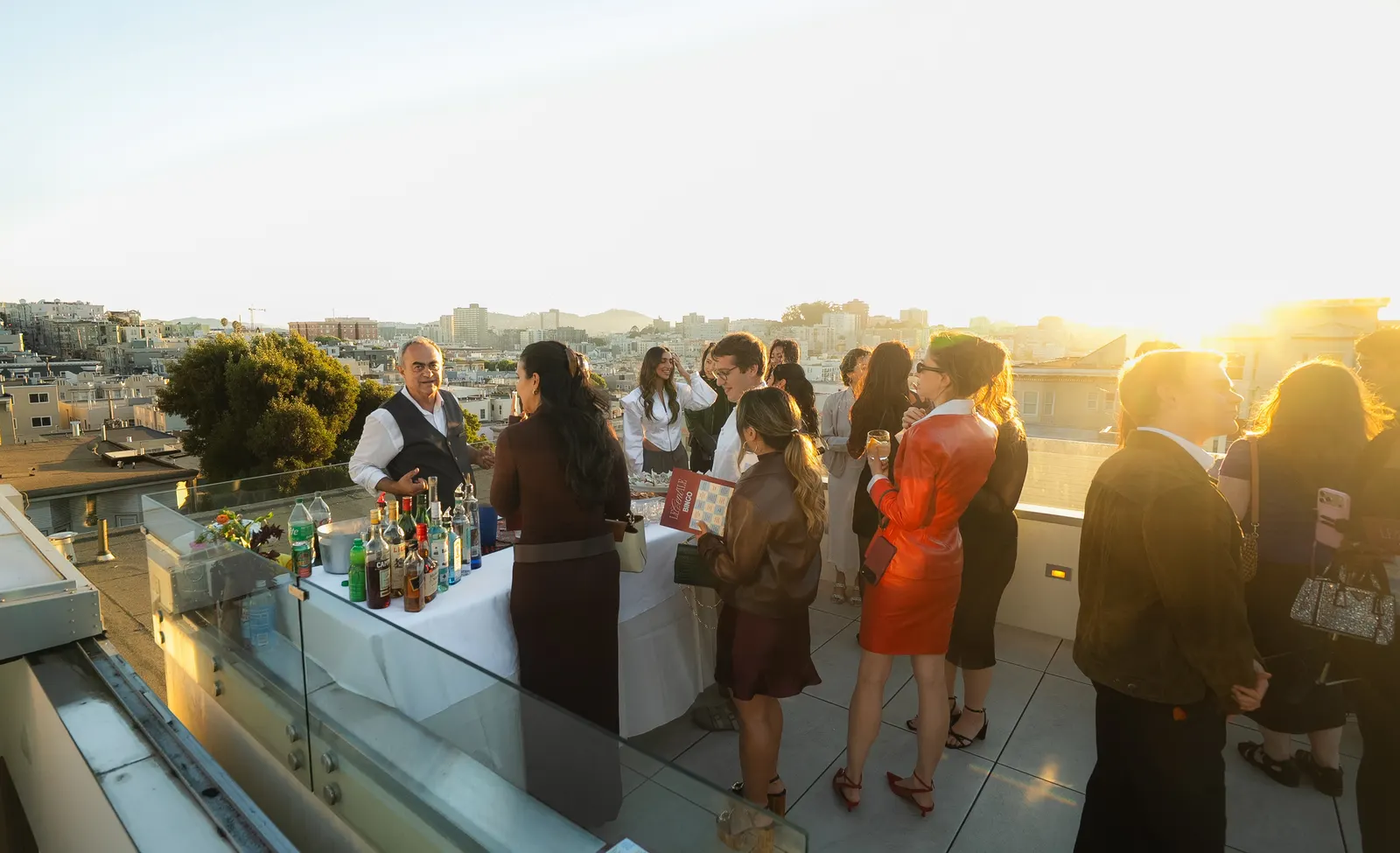Guests on a San Francisco rooftop at golden hour