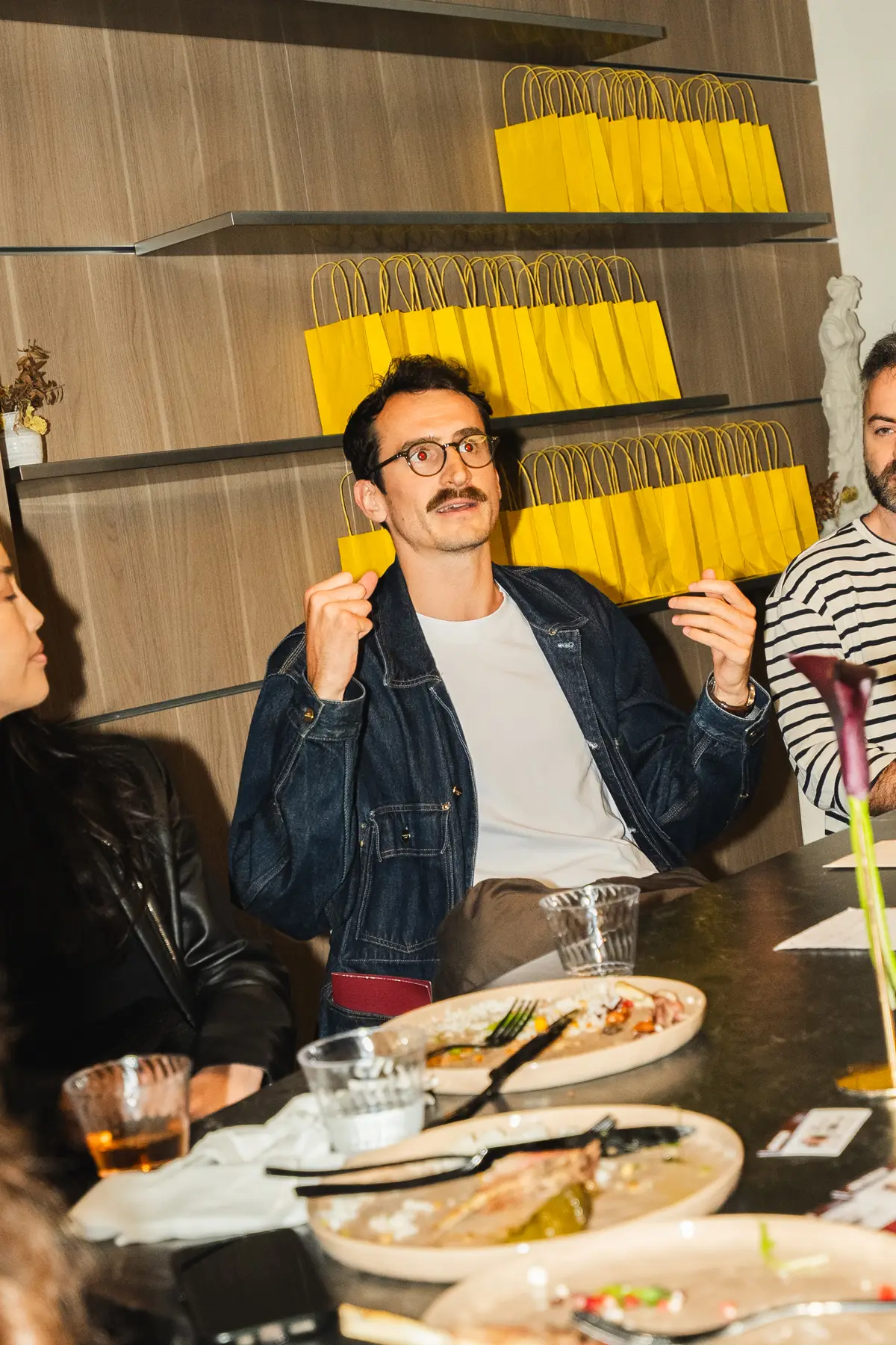 A guest laughing at the dinner table