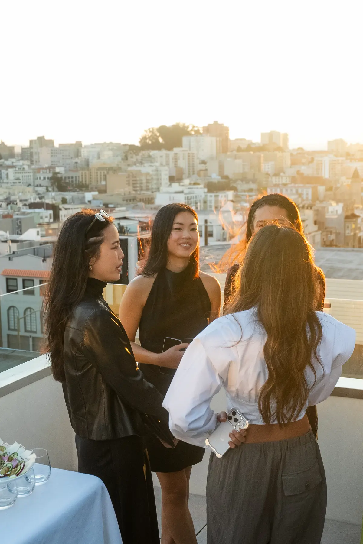 Guests talking on the rooftop above San Francisco